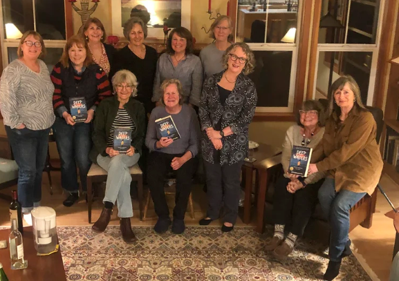 An evening reading group posing with their books